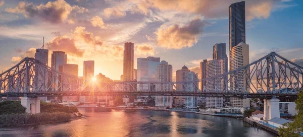 Brisbane city skyline and Story Bridge at sunset.
